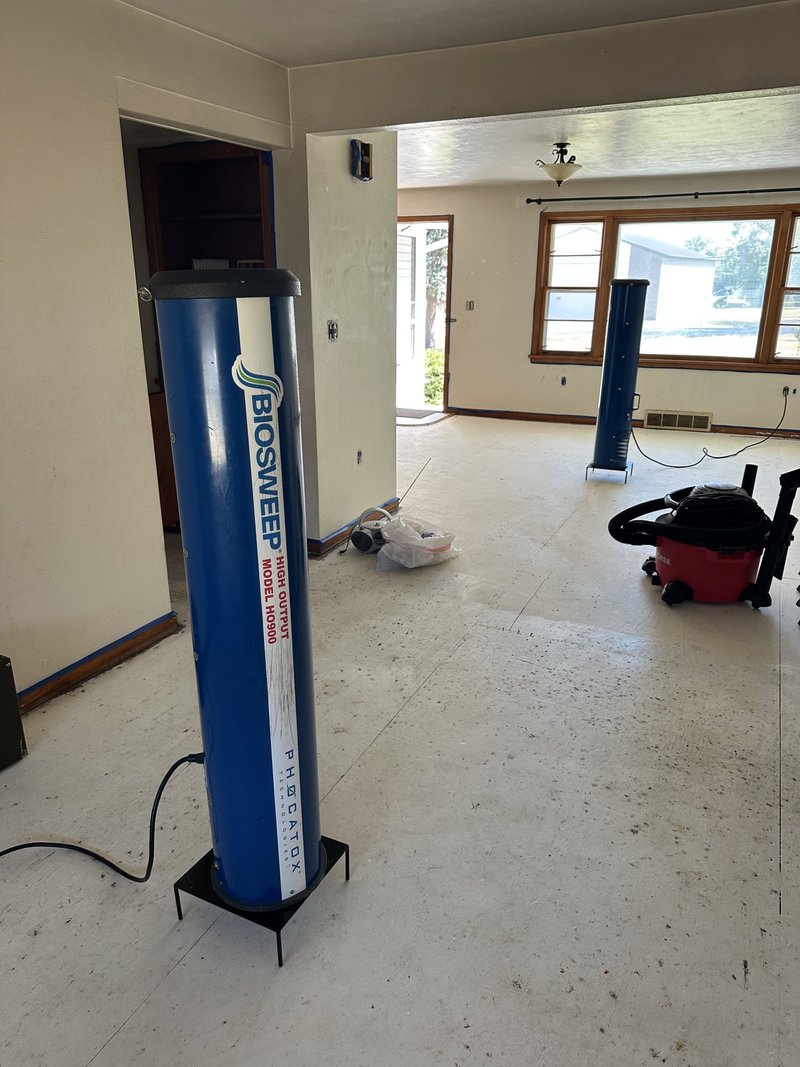BIOSWEEP machine deployed on an exposed subfloor during a pet urine odor treatment in a Chicagoland home